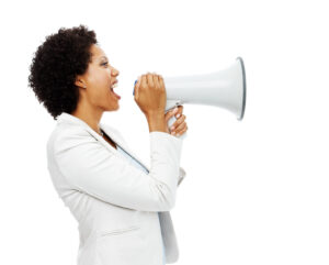 Image of a business woman shouting into a megaphone.